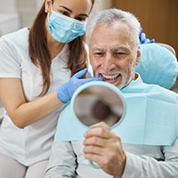 a patient receiving their dental implant restorations in Pensacola