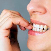 Closeup of woman biting her nails