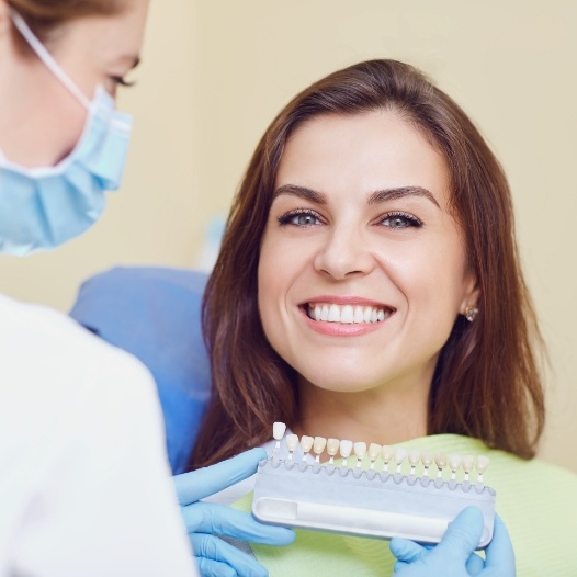 Woman's smile compared with porcelain veneers shade options