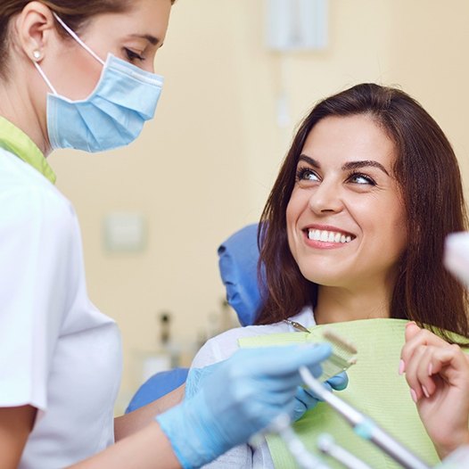 patient talking to dentist about dental crowns in Pensacola 