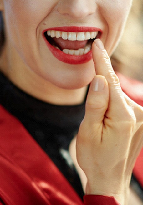 Woman smiling with dental crown in Pensacola