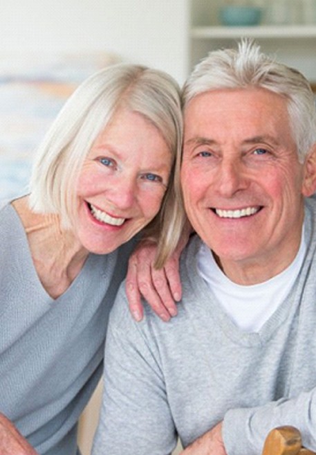 senior man and woman smiling with dentures in Pensacola