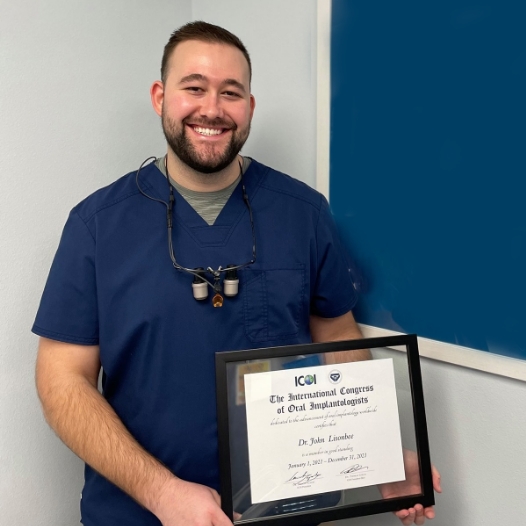 Doctor Lisonbee holding a certificate