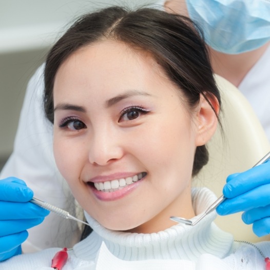 Woman receiving checkup to prevent dental emergencies