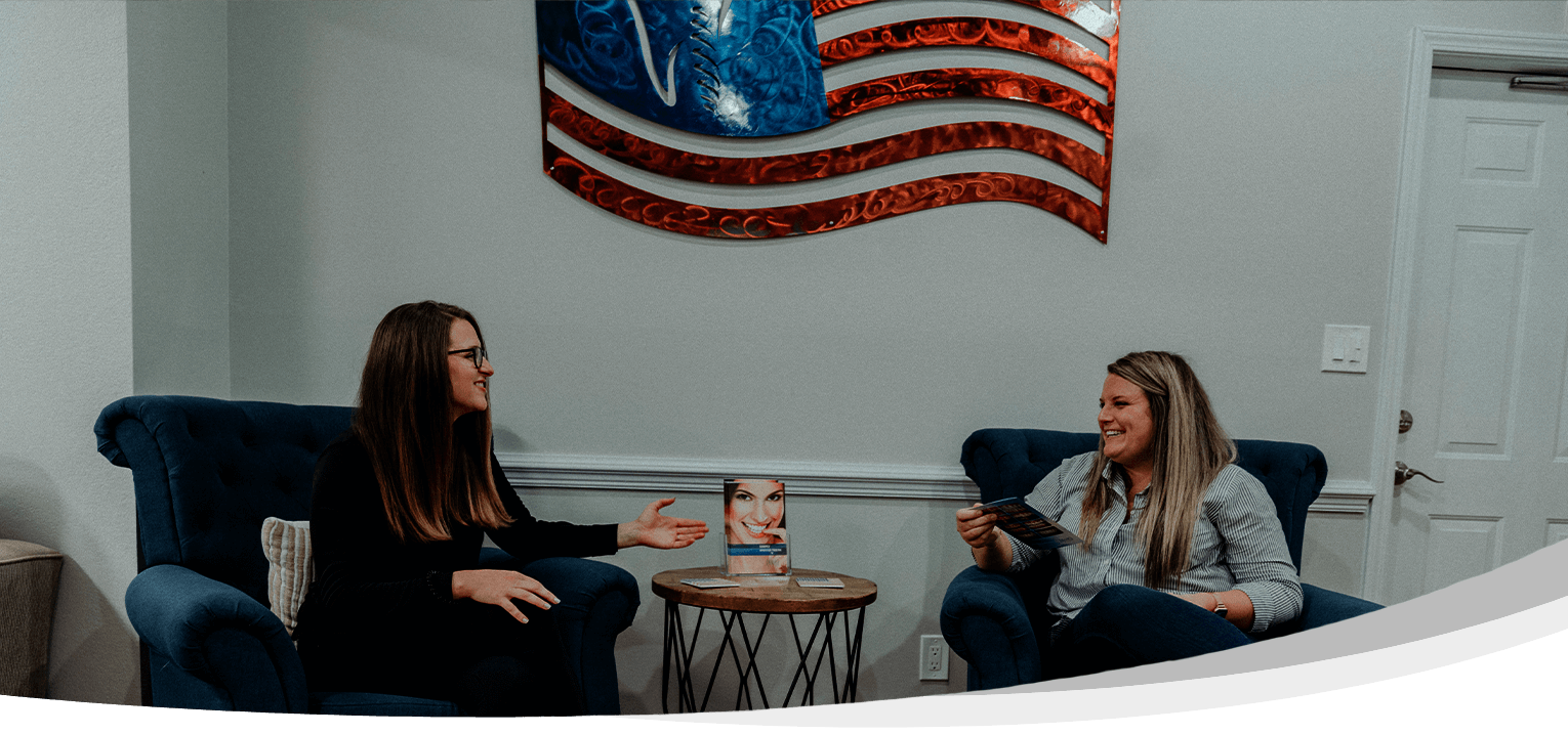 Two women sitting in Pensacola Florida dental reception area