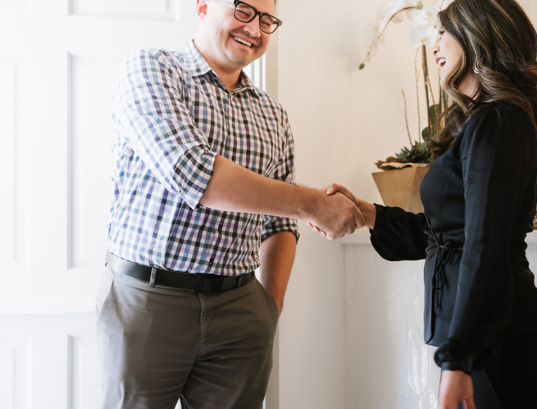 Patient shaking hands with dental team member