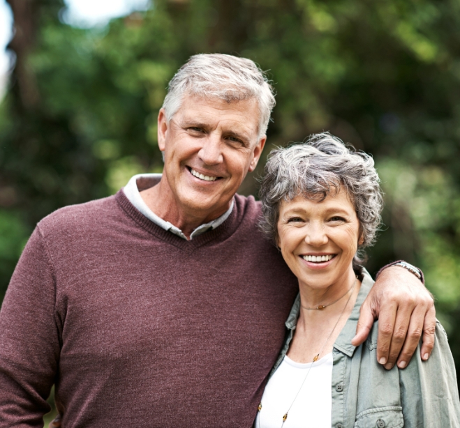 Senior man and woman smiling outdoors