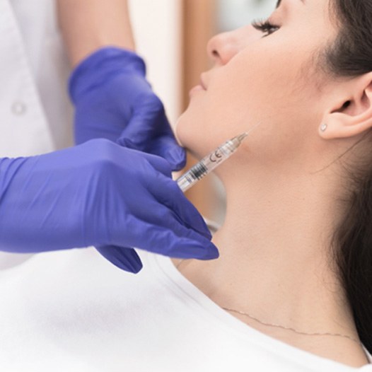 man pointing at his teeth after KöR teeth whitening in Pensacola