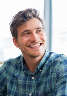 man smiling while talking to friend