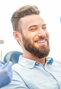 man smiling while looking in mirror 