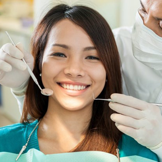 a patient smiling while visiting her dentist