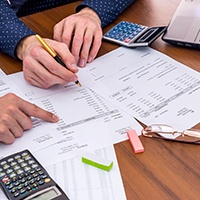 Patient in Pensacola filling out paperwork for root canal financing