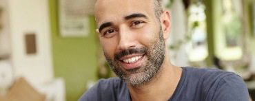 Man with full smile after replacing missing teeth