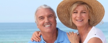 Man and woman smiling after emergency dentistry