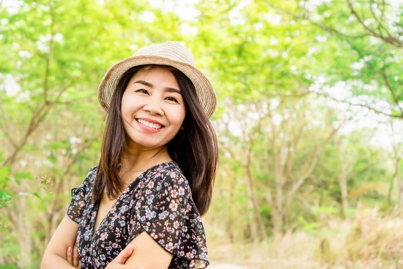 woman smiling after getting dental implants in Pensacola