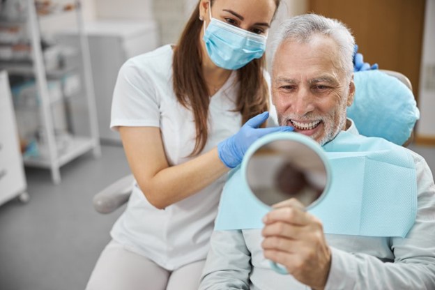 Man smiling after receiving dental implants.