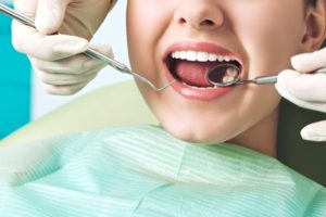 woman at the dentist getting her teeth examined