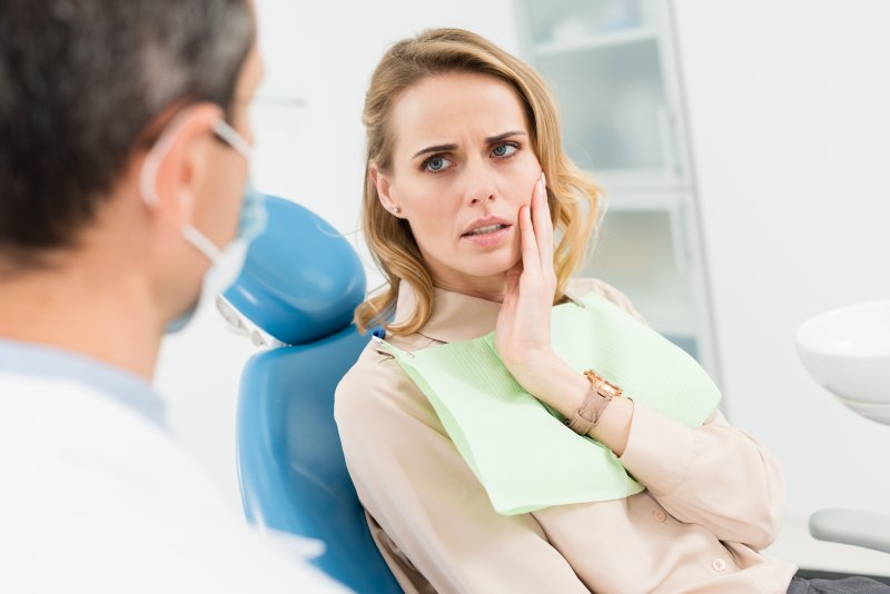 Patient looking concerned after their dental veneer fell off